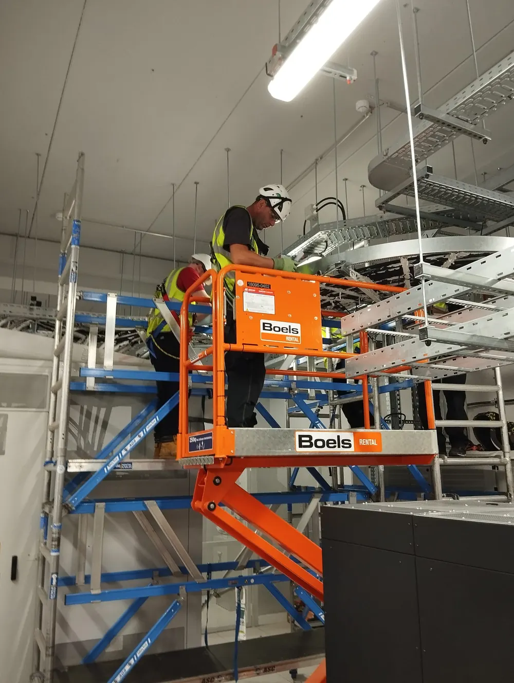 SA3 Power electricians installing prefabricated cable tray containment in a data hall