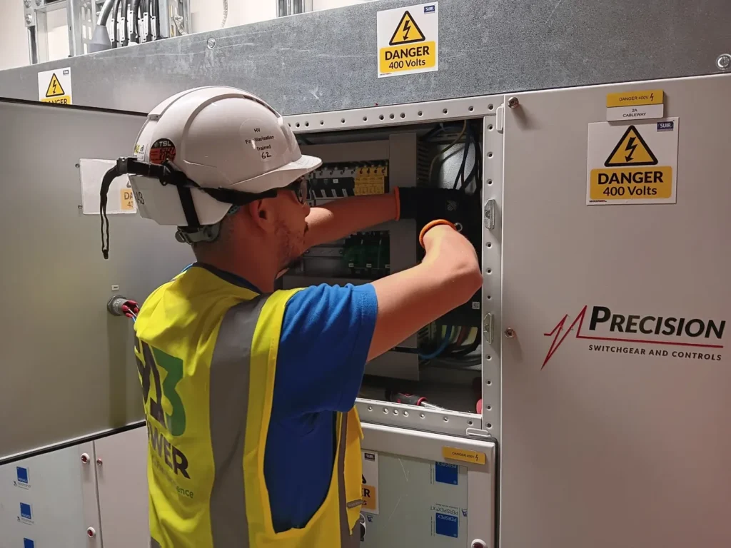 SA3 Power engineer working on control wiring inside a switchgear panel