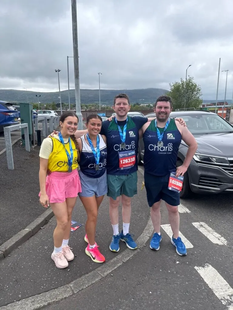 SA3 POWER relay runners with their Belfast City Marathon medals in Charis Cancer Care vests