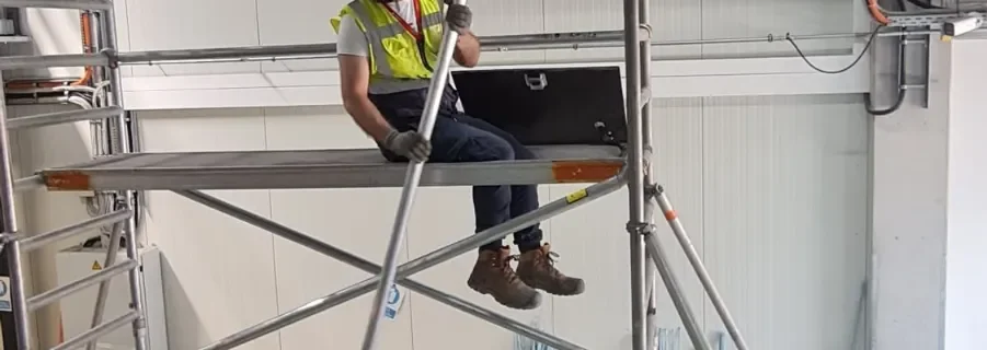 SA3 POWER delegate seated in the trapdoor of a mobile access tower during 3T assembly training in Frankfurt