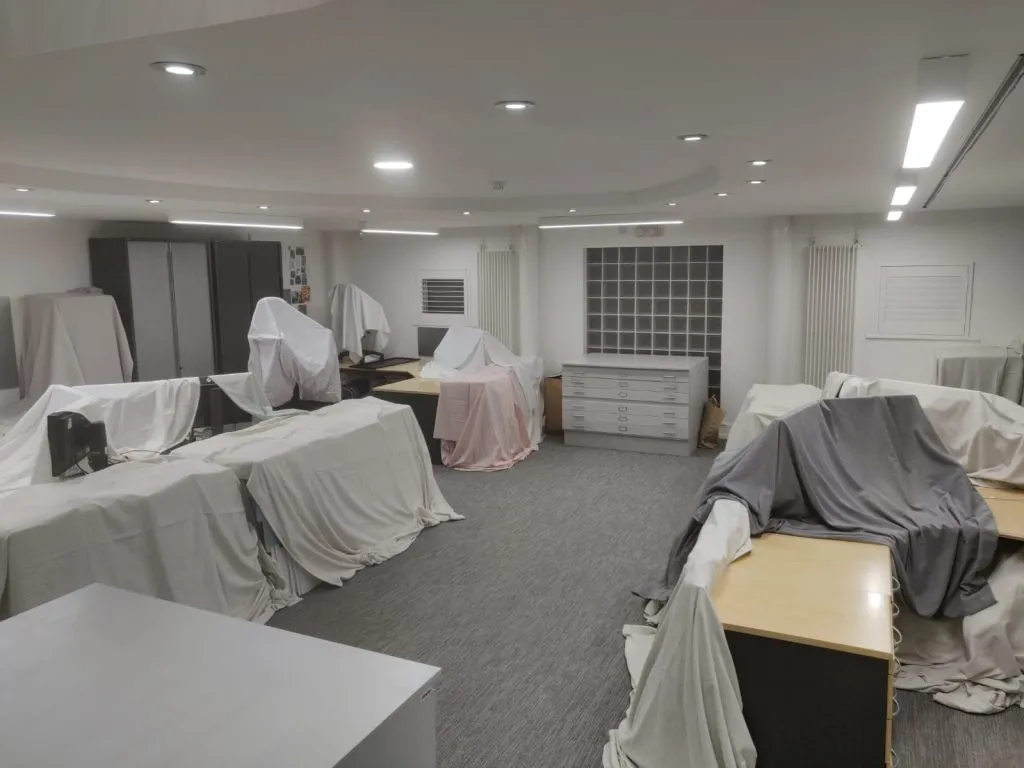 Office furniture protected with dust sheets during the First Data LED upgrade