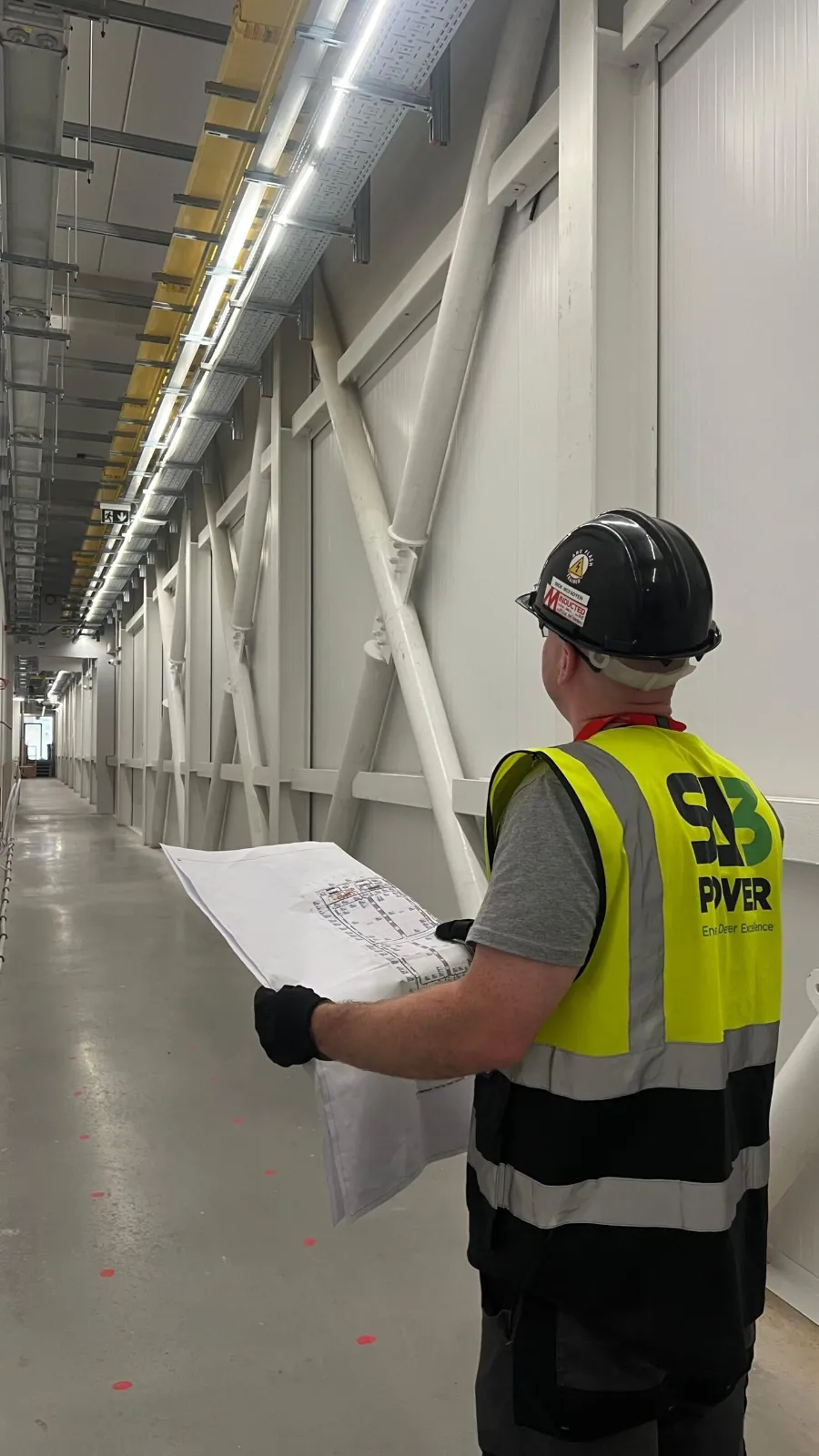 SA3 Power operative checking installation drawings during a quality inspection