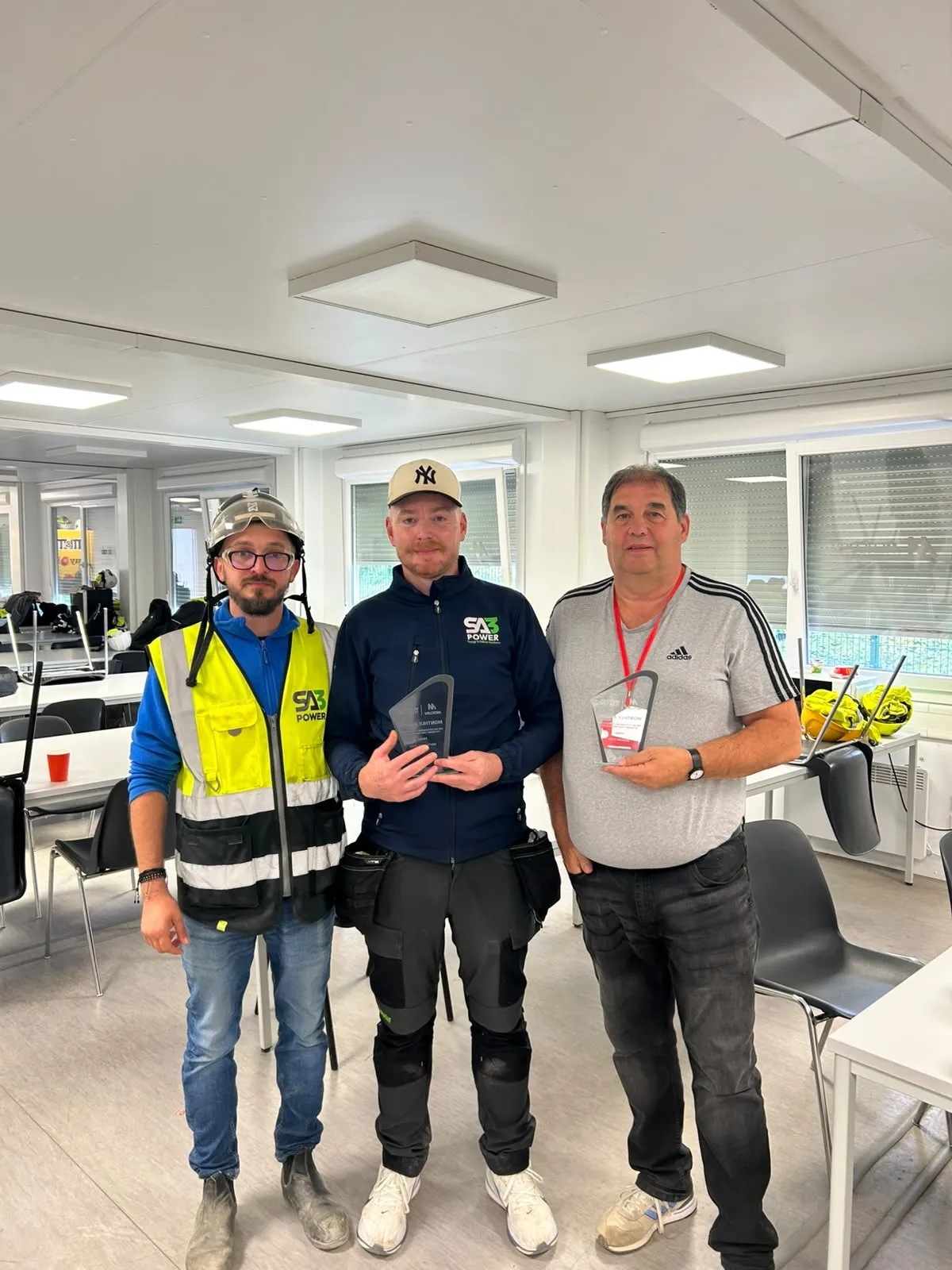 SA3 POWER team members holding Safety and Quality Trade Partner League monthly awards
