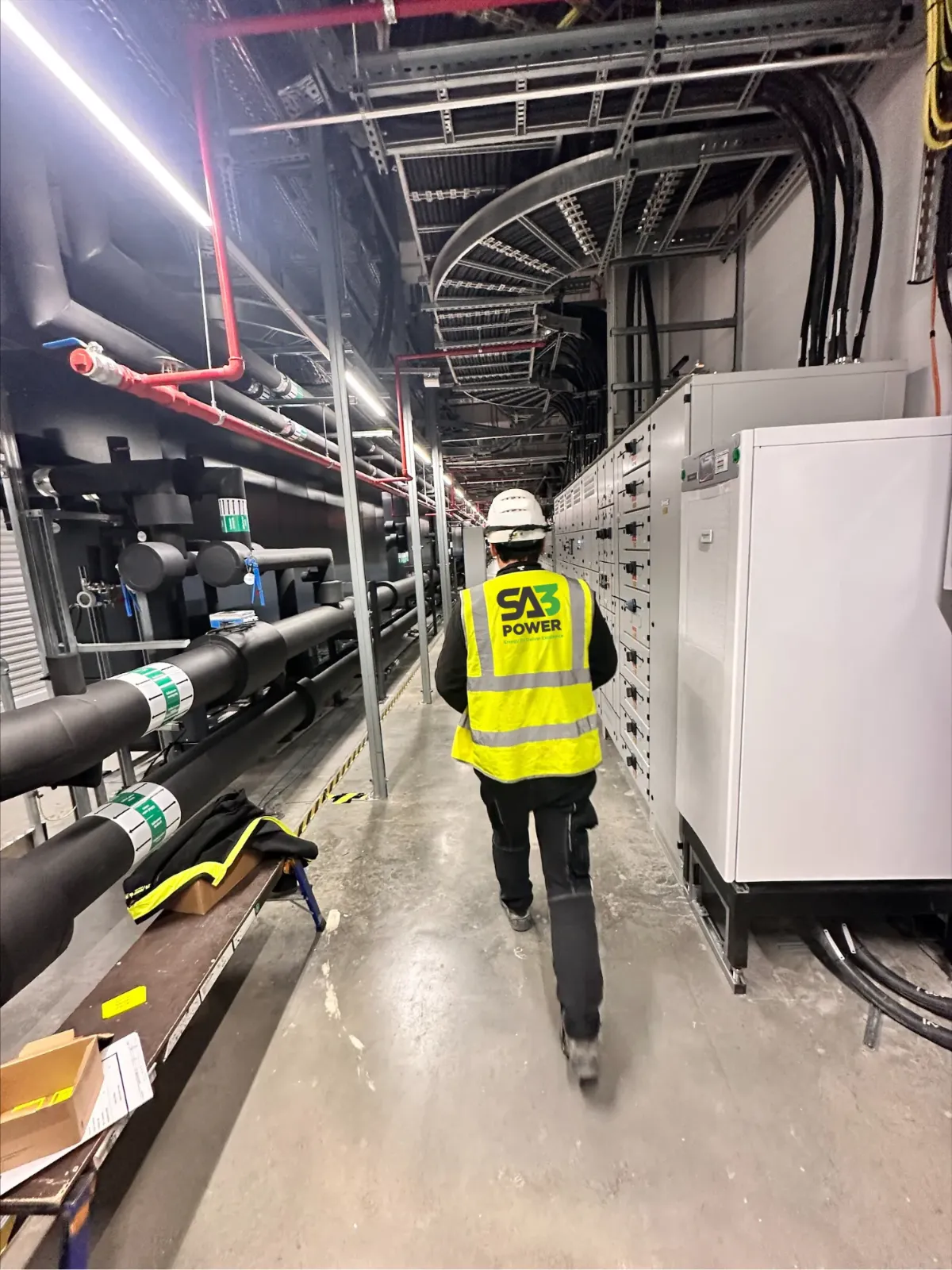 SA3 Power engineer walking through a data centre switchroom